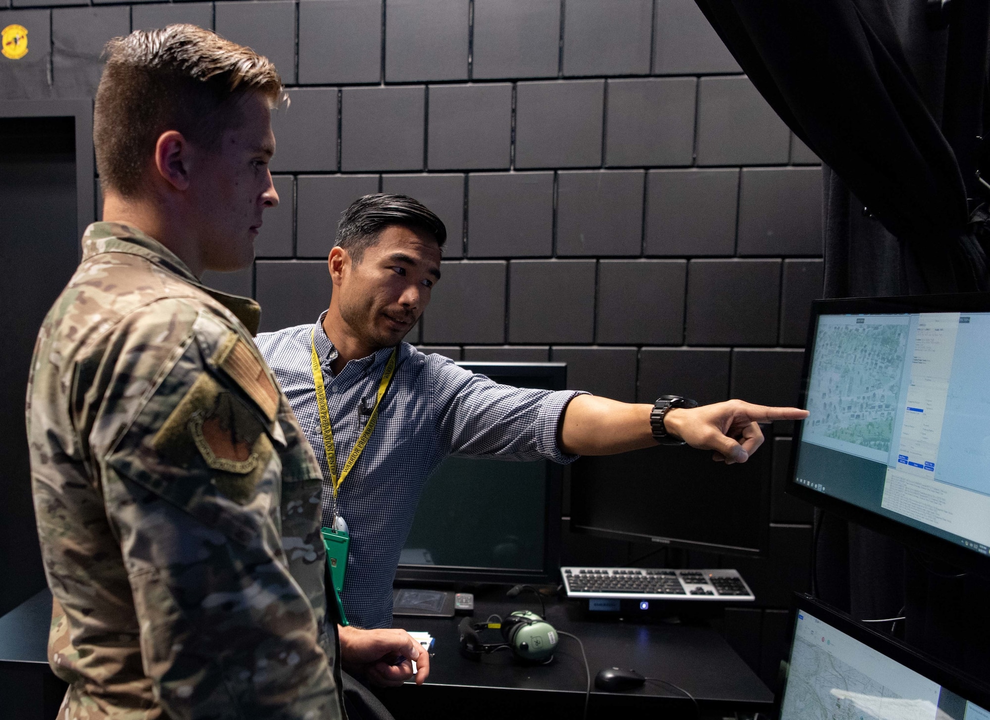 Aaron Corrales, 5th Combat Training Squadron principle specialty engineer, defines symbols on a screen to U.S. Air Force Staff Sgt. Hunter Gardski, 4th Air Support Operations Group tactical air control party Airman,