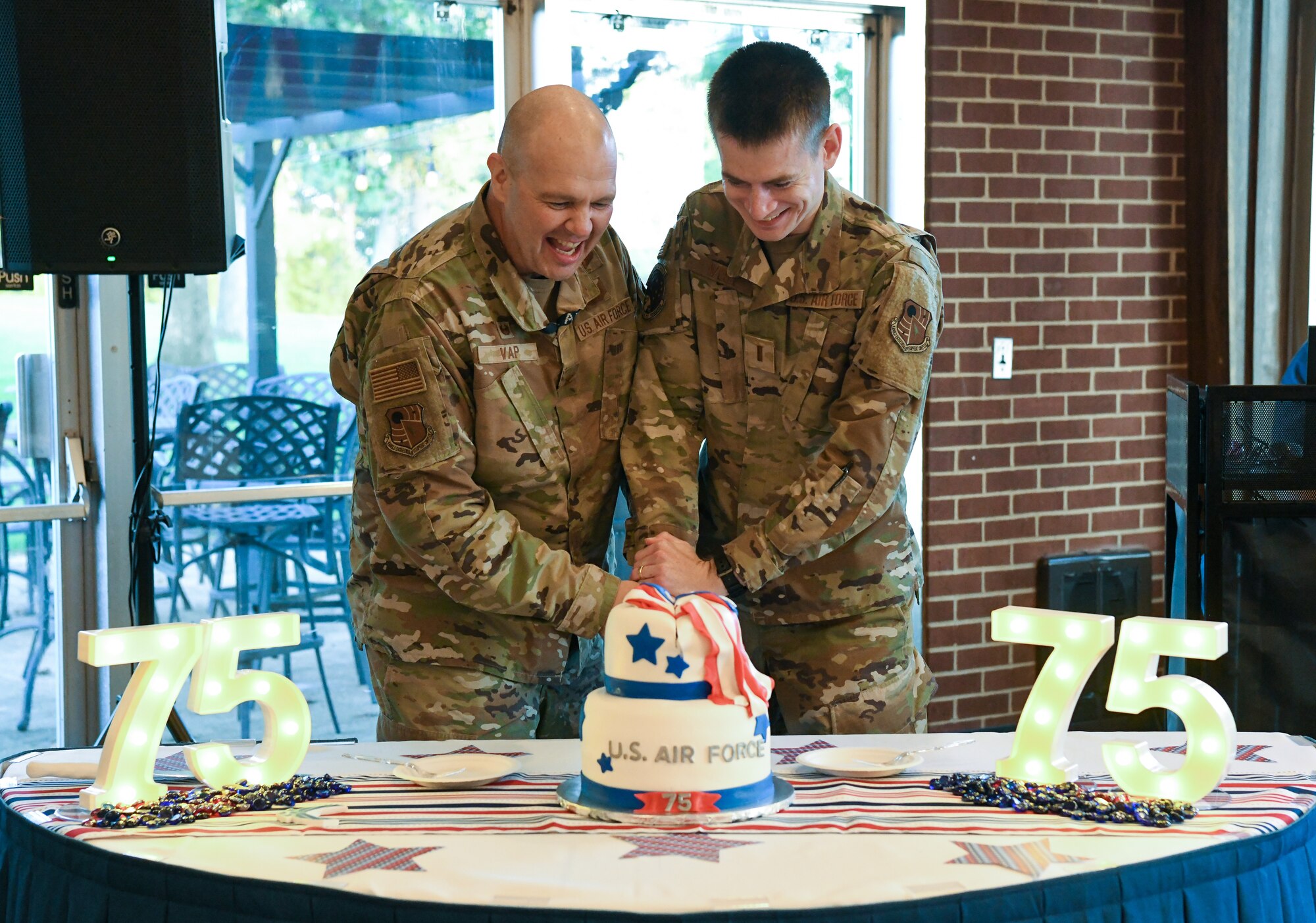 Two Airman cutting a cake with a sword