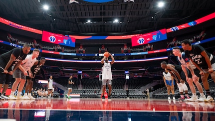 U.S. Air Force Airman 1st Class Dexavious Hall, center, United States Air Force Honor Guard ceremonial guardsman memorial colors element, attempts a free throw during a basketball game at Capital One Arena in Washington, D.C., Nov. 5, 2021. The Washington Wizards hosted the Air Force Honor Guard and U.S. Navy Ceremonial Guard from Joint Base Anacostia-Bolling to play in a tournament on the NBA court prior to hosting their Military Appreciation Night basketball game. (U.S. Air Force photo by Staff Sgt. Stuart Bright