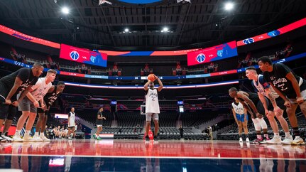 U.S. Air Force Airman 1st Class Dexavious Hall, center, United States Air Force Honor Guard ceremonial guardsman memorial colors element, attempts a free throw during a basketball game at Capital One Arena in Washington, D.C., Nov. 5, 2021. The Washington Wizards hosted the Air Force Honor Guard and U.S. Navy Ceremonial Guard from Joint Base Anacostia-Bolling to play in a tournament on the NBA court prior to hosting their Military Appreciation Night basketball game. (U.S. Air Force photo by Staff Sgt. Stuart Bright