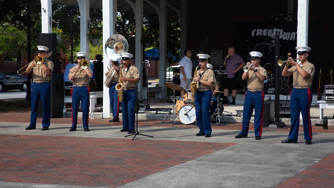 U.S. Marine Corps 2nd Marine Division Band performs during the Jacksonville's National Night Out event in Riverwalk Park, Jacksonville, North Carolina, Aug. 2, 2022. National Night Out is a celebration of the partnership between the city of Jacksonville, MCB Camp Lejeune representatives and community partners, highlighting the support between the base, community services and public safety officials. (U.S. Marine Corps photo by Lance Cpl. Trey Q. Michael)
