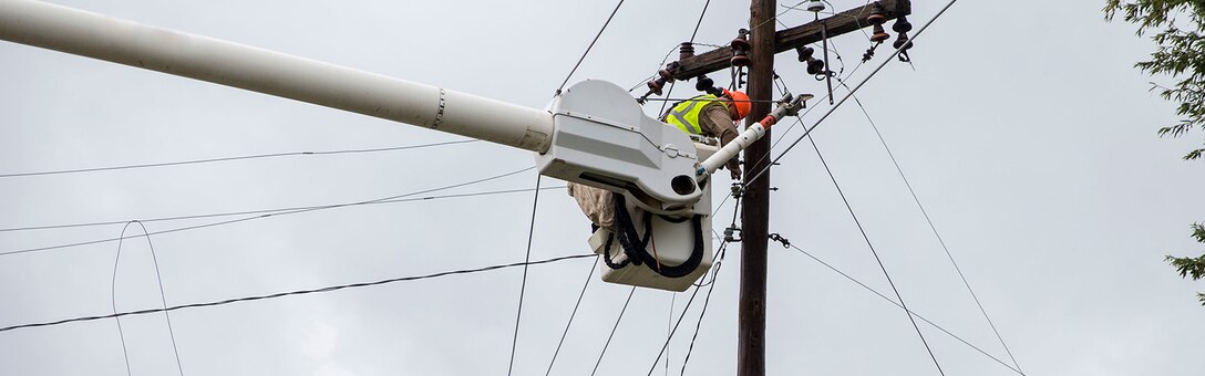 Utility workers with JCL Power Boyce L.A., repair damaged power lines on Marine Corps Air Station New River, N.C., Sept. 16, 2018. Hurricane Florence impacted Marine Corps Base Camp Lejeune and MCAS New River with periods of strong winds, heavy rains, flooding of urban and low lying areas, flash floods and coastal storm surges.  (U.S. Marine Corps photo by Lance Cpl. Damaris Arias). Cropped version of 180916-M-KW786-015