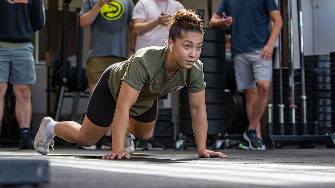 U.S. Marine Corps Cpl. Nahla Beard, an Air Traffic Controller with Headquarters and Headquarters Squadron, attempts a Guinness world record at Marine Corps Air Station Iwakuni, Japan, August 7, 2021. Cpl. Beard won the Guinness world record for most chest-to-ground burpees in one minute.