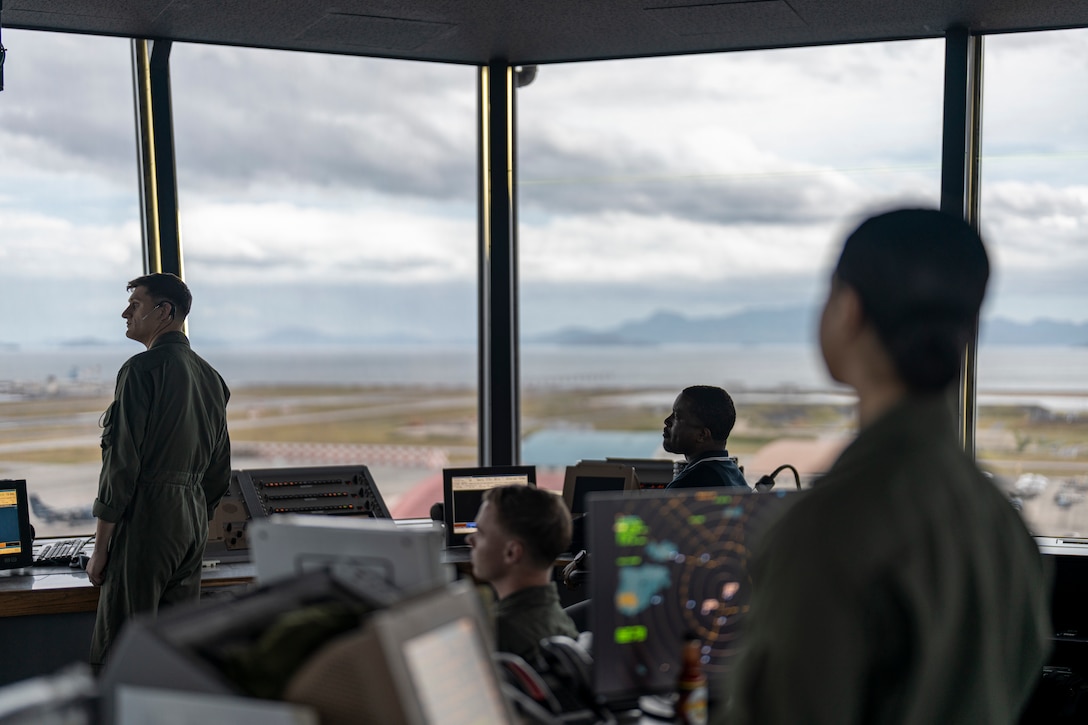 Marines with Air Traffic Control conduct flight operations in the ATC tower at Marine Corps Air Station Iwakuni, Japan, August 16, 2022. Sgt. Beard, who holds the Guinness world record for most chest-to-ground burpees in one minute, works at the ATC tower as an ATC supervisor.