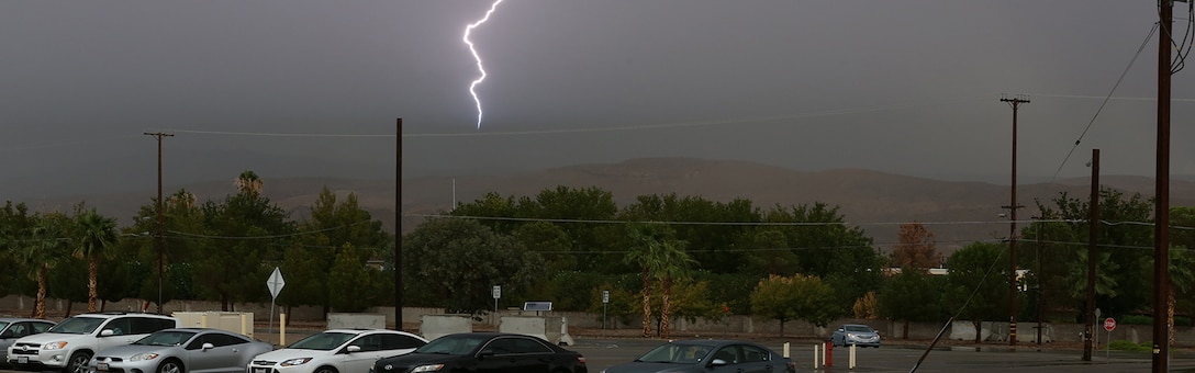 A bolt of lightning flashes over the hills of Barstow, Calif., Aug. 19, during a heavy rain storm that brought thunder, lightning and flash flooding. As a result of the storm, communities in Barstow were left without power and flooded streets. Cropped version of 130819-M-ss662-004