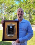 man holding award