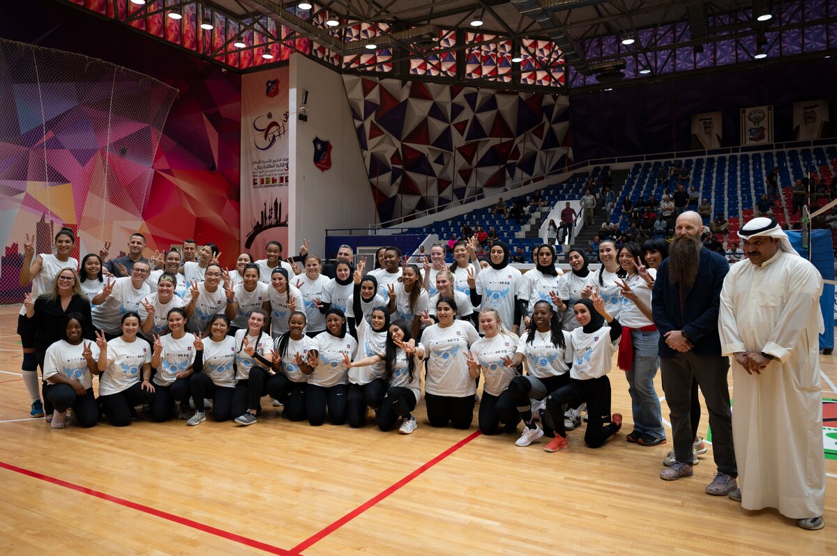 U.S. and Kuwait Senior leaders, Soldiers, Airmen and Kuwait volleyball players pose for a photo at the Kuwait Sports Club, Kuwait, October 1, 2022. Six teams from Ali Al Salem Air Base, Camp Buehring, Camp Arifjan and Kuwaiti players from the Kuwait Sports Club Women’s Volleyball Team came together for a day centered around celebration and peace. (U.S. Air Force photo by Staff Sgt. Dalton Williams)