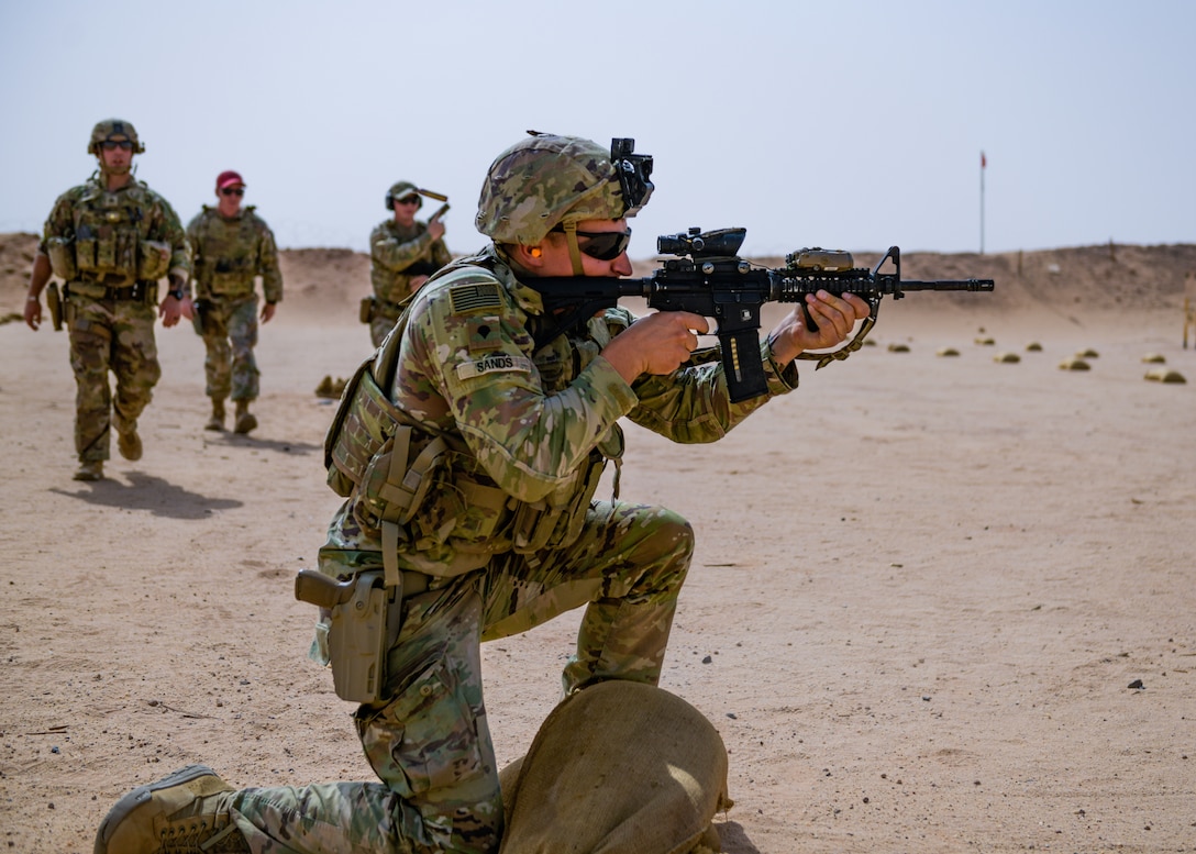 A U.S. Soldier with Task Force Americal from the 1st Battalion, 182nd Infantry Regiment, provides cover fire for Senior Airman Scott Prouty, a fireteam member assigned to the 378th Expeditionary Security Force Squadron, during a Joint Force combat arms training at Prince Sultan Air Base, Kingdom of Saudi Arabia, Sept. 24, 2022. Soldiers and Airmen must undergo routine weapons qualification training to ensure safety and proficiency standards, which they meet together at PSAB. (U.S. Air Force photo by Staff Sgt. Noah J. Tancer)