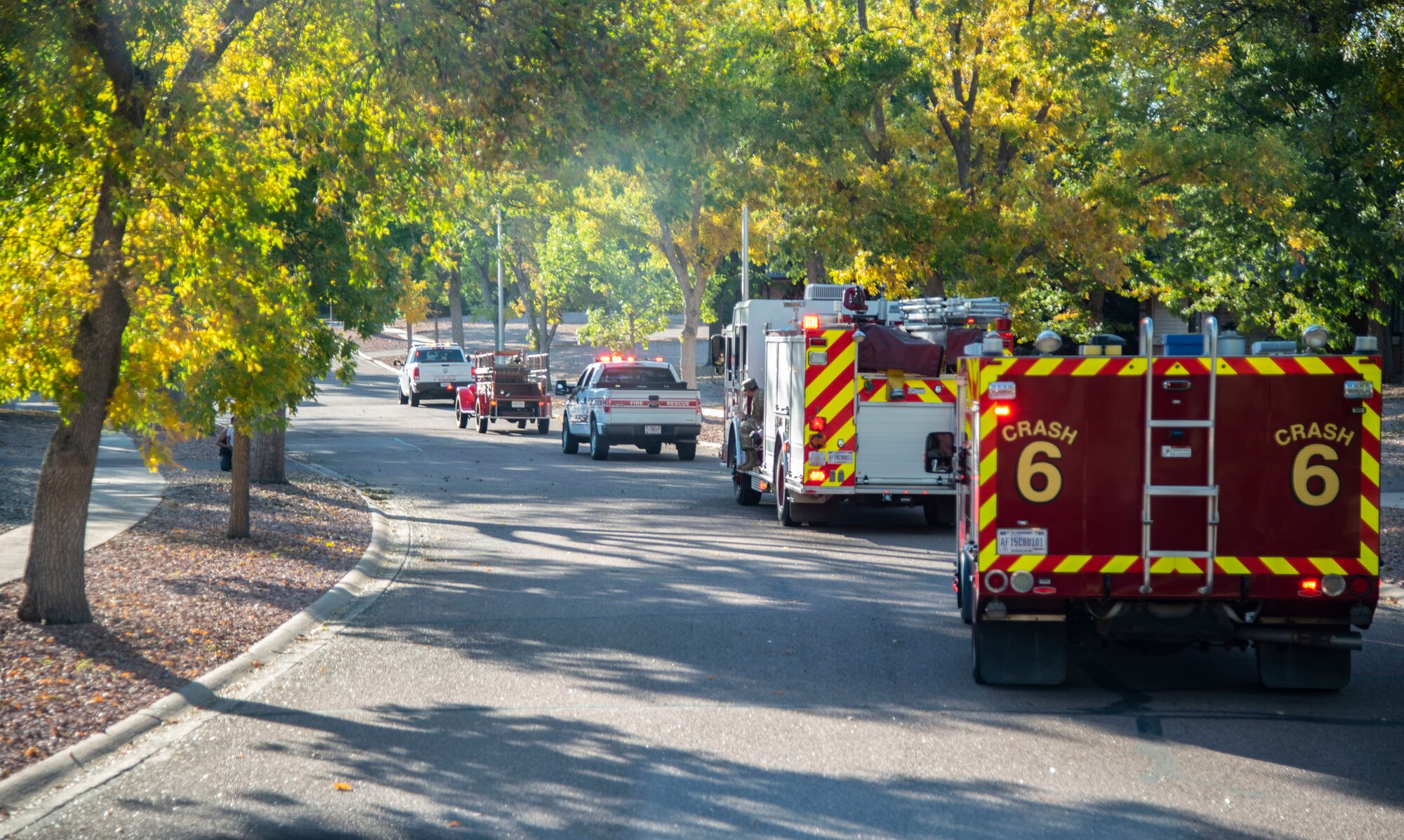 Firefighters from the 21st Civil Engineer Squadron parade through base housing as part of Fire Prevention Week at Peterson Space Force Base, Colorado, Oct. 5, 2021.