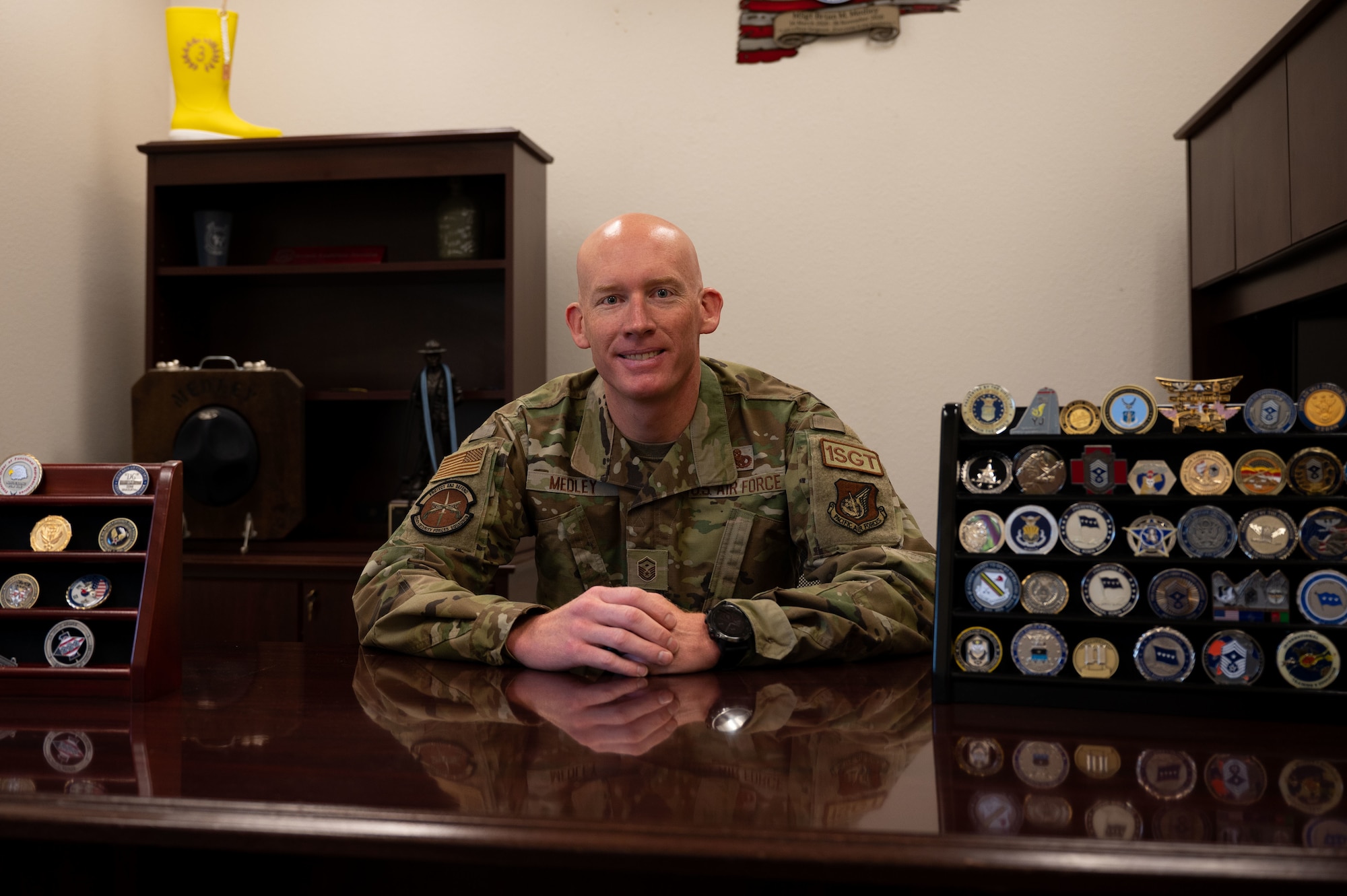 A man poses for a photo in his office