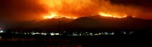 U.S. Marines and fire crew on Marine Corps Base Camp Pendleton, Calif., respond to wildfires ablaze in southern California May 14, 2014. The Tomahawk fire, in the northeast section of Camp Pendleton has burned more than 6,000 acres forcing evacuations of housing areas on base and various schools both on and off base. Aircraft from 3rd Marine Aircraft Wing and the Camp Pendleton Fire Department worked in coordination with CALFIRE to prevent fires from spreading off base. Marine officials are coordinating with CALFIRE for the further use of military aircraft pending the wildfire status within San Diego County. Cropped version of 140515-M-Ls369-130