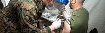 U.S. Navy Hospital Corpsman Liam Morgan, left, a task force safeguard corpsman, administers the second COVID-19 vaccination to U.S. Marine Corps Col. David Banning, the commanding officer of Marine Rotational Force - Darwin, at Okinawa Naval Hospital, Camp Foster, Okinawa, Japan, Feb. 5, 2021. MRF-D and the Okinawa Naval Hospital worked together to schedule times for Marines and Sailors attached to MRF-D to opt in and receive both of the COVID-19 vaccinations before deploying to Australia. (U.S. Marine Corps photo by Sgt. Micha Pierce) Cropped version of 210205-M-MH051-1012
