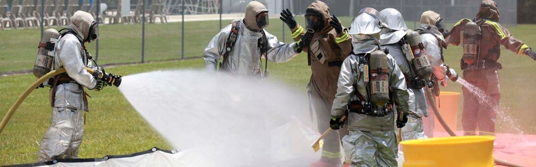 U.S. Marines assigned to Aircraft Rescue Fire Fighting decontaminate members of the Marine Corps Air Station Beaufort fire department at the sight chemical spill at the training pool aboard Marine Corps Air Station Beaufort, South Carolina, July 19, 2013. Approximately 150 gallons of sodium hypochlorite was spilled in the vicinity of the pool, emergency personnel from the Air Station, Parris Island and Beaufort County responded and contained and removed the source of the leak. (U.S. Marine Corps photo by Lance Cpl. Patrick J. McMahon/ Released) Cropped version of 130719-M-VR358-083