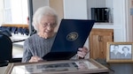 Florence Manchester Smith reads a letter from Admiral Linda Fagan, Commandant of the Coast Guard, presented to her in honor of her 100th birthday, Thursday, Sept. 29, 2022. Smith enlisted in the Coast Guard in December 1943 as part of the SPARs, the all-female workforce that was mobilized during World War II. (U.S. Coast Guard photo by Lt. Pamela Manns)