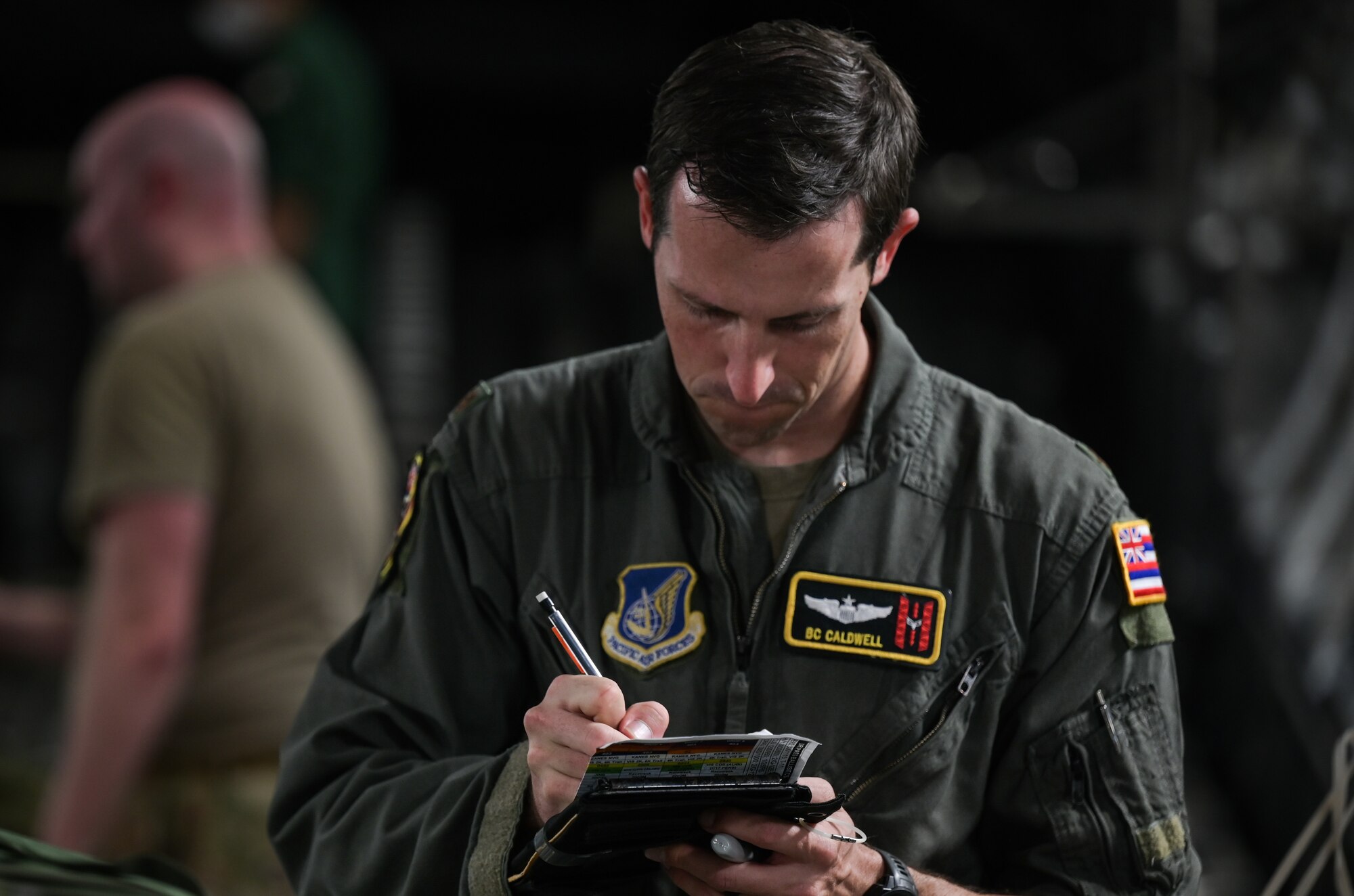 U.S. Air Force Maj. Brittain Caldwell, 204th Airlift Squadron C-17 Globemaster III pilot, checks cargo on a C-17 Globemaster III during a bilateral exercise with Japan Air Self-Defense Force 403rd Tactical Airlift Squadron members at Joint Base Pearl Harbor-Hickam, Hawaii, Sept. 28, 2022. Over 20 JASDF personnel arrived to participate in the first bilateral exercise between the Kawasaki C-2 and the C-17. (U.S. Air Force photo by Staff Sgt. Alan Ricker)