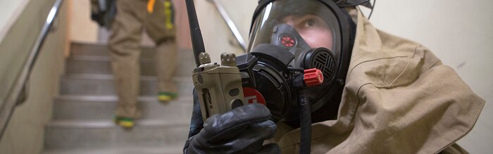 Cpl. Albert Gaston, a chemical, biological, radiological and nuclear (CBRN) defense specialist with the CBRN response element (CRE), 31st Marine Expeditionary Unit, relays a report while inspecting a building for mock contamination during CBRN response training at Camp Hansen, Okinawa, Japan, Feb. 1, 2017. The CRE conducted full scale detection and decontamination training with Marine Corps Installations Pacific - Fire and Emergency Services personnel observing. As the Marine Corps’ only continuously forward-deployed unit, the 31st MEU air-ground-logistics team provides a flexible force, ready to perform a wide range of military operations, from limited combat to humanitarian assistance operations, throughout the Indo-Asia Pacific region. (U.S. Marine Corps photo by Cpl. Darien J. Bjorndal/ Released) Cropped version of 170201-M-MF313-114