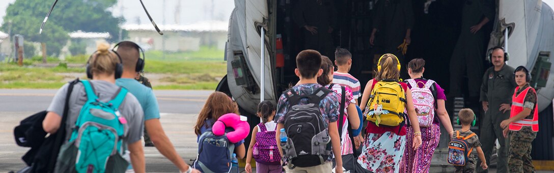 MARINE CORPS AIR STATION FUTENMA, OKINAWA, Japan – Department of Defense volunteers begin to board a C-130 for an Evacuation Control Center rehearsal August 7 on Marine Corps Air Station Futenma, Okinawa, Japan. The ECC rehearsal for 3D Transportation Battalion Alert Contingency Marine Air Ground Task Force ensured the ECC is fully prepared and ready if a national disaster arises. The ECC rehearsal gives commanders the opportunity to evaluate the performance of their Marines and the equipment’s capabilities. (U.S. Marine Corps photo by Lance Cpl. Andrè T. Peterson Jr.) Cropped version of 180807-M-OE725-0030