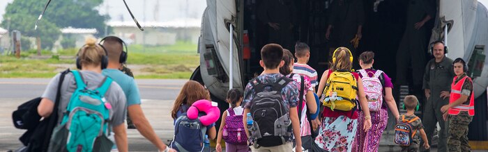 MARINE CORPS AIR STATION FUTENMA, OKINAWA, Japan – Department of Defense volunteers begin to board a C-130 for an Evacuation Control Center rehearsal August 7 on Marine Corps Air Station Futenma, Okinawa, Japan. The ECC rehearsal for 3D Transportation Battalion Alert Contingency Marine Air Ground Task Force ensured the ECC is fully prepared and ready if a national disaster arises. The ECC rehearsal gives commanders the opportunity to evaluate the performance of their Marines and the equipment’s capabilities. (U.S. Marine Corps photo by Lance Cpl. Andrè T. Peterson Jr.) Cropped version of 180807-M-OE725-0030