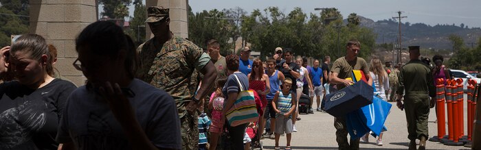 U.S. Marines and spouses check in to the temporary evacuation control center established in the Paige Fieldhouse to escape a fire in the De Luz housing area at Marine Corps Base Camp Pendleton, July 6, 2018. (U.S. Marine Corps photo by Cpl. Lukas Kalinauskas) Cropped version of 180706-M-GL893-1114