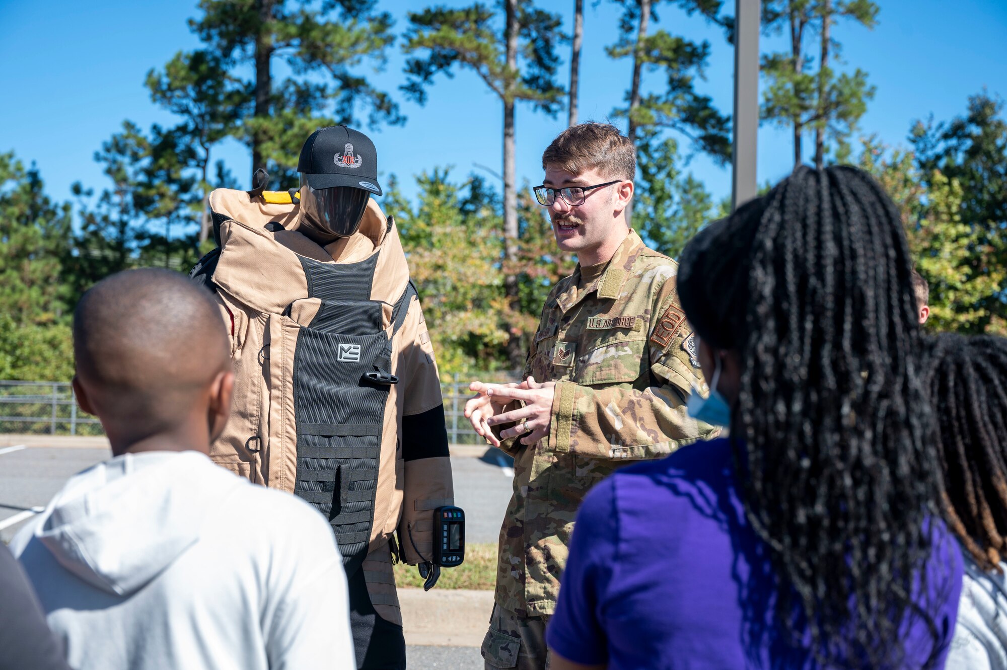 An explosive ordnance disposal technician demonstrates a bomb suit