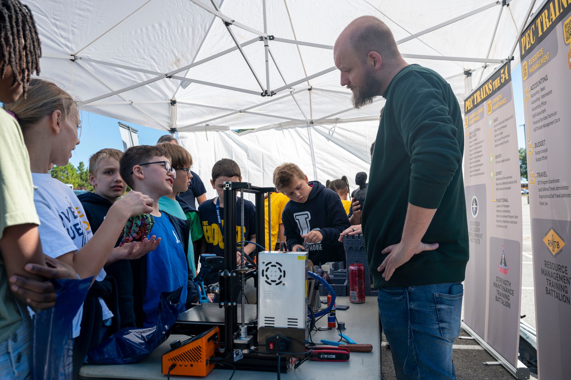 Professional Education Center (PEC) staff demonstrate a 3D printer