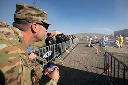 Alaska Air National Guard Tech Sgt. Ryan Smith, 176th Wing Civil Engineer Squadron, observes a Mongolia National Emergency Management Agency team demonstrate hazmat decontamination procedures during exercise Gobi Wolf 2022 in Bayankhongor, Mongolia, Sept. 10. Gobi Wolf is a disaster response exercise conducted as a humanitarian assistance and disaster relief engagement. The FTX focuses on hazmat response, mass medical care and search and rescue. Participating countries also include Bangladesh, Nepal, Sri Lanka, Thailand, the United Kingdom and Vietnam. (Alaska National Guard photo by Victoria Granado)