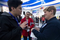 Alaska firefighter and paramedic Breanna Love, right, Palmer Fire and Rescue, speaks with M. Munguntsetseg, head of the local Red Cross, through A. Saingileg, a translator, about local disaster response during a table top exercise as part of exercise Gobi Wolf 2022 in Bayankhongor, Mongolia, Sept. 7. Gobi Wolf is a disaster response exercise designed to test processes while maximizing realism through a series of scenarios. It will consist of a field training exercise in mass medical care, hazmat response and search and rescue. (Alaska National Guard photo by Victoria Granado)