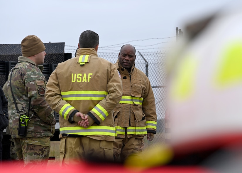 Col. Todd Randolph, 316th Wing and installation commander, speaks with Col. Graham Auten, 316th Wing Civil Engineer Squadron commander, before the Fire Prevention Week proclamation signing at Joint Base Andrews, Md., Oct. 4, 2022. From Oct. 9 - Oct. 15, JBA will host events such as a fire truck parade and a fire station open house and barbeque to raise fire safety awareness and educate families, students and communities across JBA. (U.S. Air Force photo by Airman 1st Class Austin Pate)