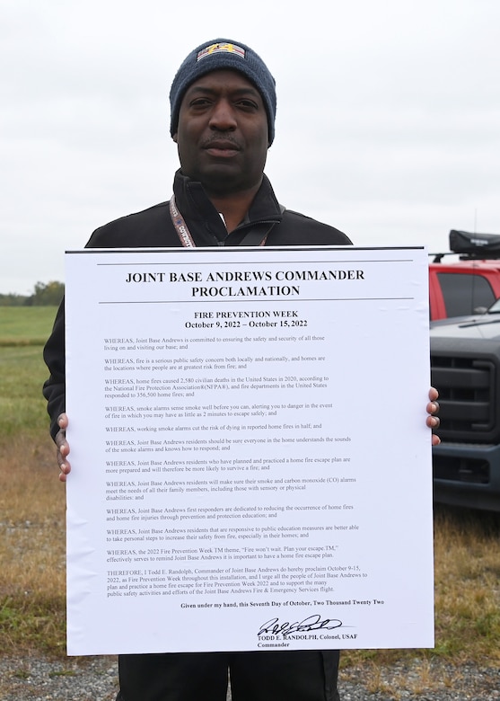 Timothy Williams, 316th Wing Civil Engineer Squadron assistant chief to fire prevention, holds a proclamation to designate the second week of October as Fire Prevention Week at Joint Base Andrews, Md., Oct. 4, 2022. The Department of Defense and JBA observe the second week in October as Fire Prevention Week to highlight fire safety awareness and to educate families, students and communities across JBA. (U.S. Air Force photo by Airman 1st Class Austin Pate)