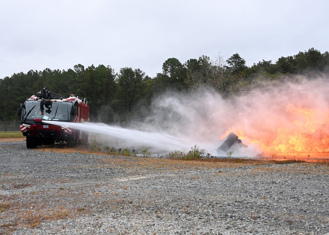 A 316th Civil Engineer Squadron fire truck extinguishes a fire during the Fire Prevention Week proclamation signing at Joint Base Andrews, Md., Oct. 4, 2022. The Department of Defense and JBA observe the second week in October as Fire Prevention Week to highlight fire safety awareness and to educate families, students and communities across JBA. (U.S. Air Force photo by Airman 1st Class Austin Pate)