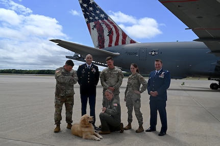 Back row, Sgt. 1st Class Jason Collins, Capt. Mario Rey, Staff Sgt. Dean VanTassel, Senior Airman Victoria Johnson, Capt. Jeremiah Neault; in front: Tech. Sgt. Natalie Belongie and Pack, the 157th Air Refueling Wing’s official mascot, pose near the flight line at Pease Air National Guard Base in Newington, New Hampshire, on Aug. 10, 2022.
