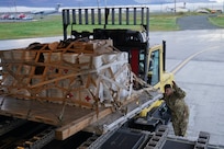 Alaska Air National Guardsmen of 144th Airlift Squadron and 176th Logistics Readiness Squadron load relief supplies bound for Nome Sept. 30, 2022, on a C-17 Globemaster III. More than 130 members of the Alaska Organized Militia, which includes members of the Alaska National Guard, Alaska State Defense Force and Alaska Naval Militia, were activated following a disaster declaration issued Sept. 17 after the remnants of Typhoon Merbok caused dramatic flooding across more than 1,000 miles of Alaskan coastline.  (Alaska National Guard photo by Dana Rosso)