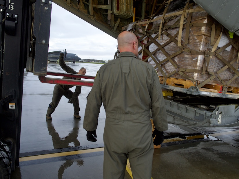 Alaska Air National Guardsmen of 211th Rescue Squadron and 176th Logistics Readiness Squadron load relief supplies bound for Bethel Sept. 29, 2022, on an HC-130J Combat King II. More than 130 members of the Alaska Organized Militia, which includes members of the Alaska National Guard, Alaska State Defense Force and Alaska Naval Militia, were activated following a disaster declaration issued Sept. 17 after the remnants of Typhoon Merbok caused dramatic flooding across more than 1,000 miles of Alaskan coastline. (Alaska Air National Guard photo by David Bedard)