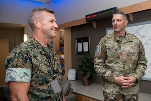 Two military men speak to eachother