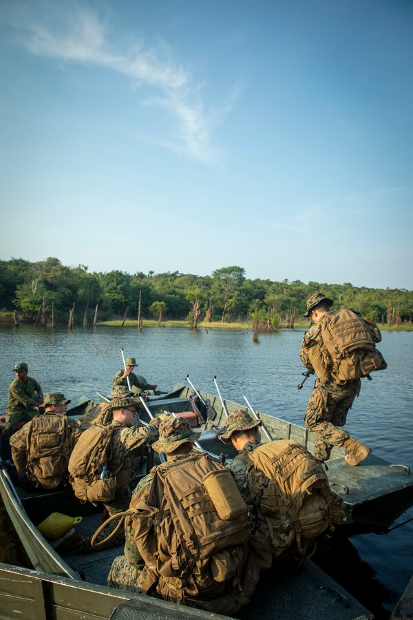 U.S. Marines and Sailors with 2d Battalion, 2d Marine Regiment, 2d Marine Division, sit in a Brazilian “troop carrier” boat during a bilateral jungle training event in Manaus, Brazil, Sept. 26, 2022. These boats are used for insert, extract, and medical support along the many rivers and waterways of the jungle. U.S. partnerships in the U.S. Southern Command area of responsibly are forged by shared challenges and common objectives. Bilateral training events such as jungle training develops and sustains relationships that improve the capacity of U.S. and partner nation maritime forces to achieve common desired effects. This exchange of knowledge between critical regional partners fosters interoperability, friendly relationships, and mutual cooperation. (U.S. Marine Corps photo by Sgt. Camila Melendez)