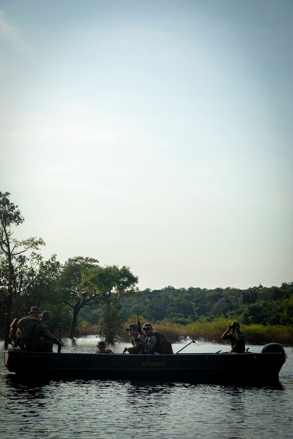 U.S. Marines and Sailors with 2d Battalion, 2d Marine Regiment, 2d Marine Division, ride in a Brazilian “troop carrier” boat prior to a land navigation course during a bilateral jungle training event in Manaus, Brazil, Sept. 26, 2022. These boats are used for insert, extract, and medical support along the many rivers and waterways of the jungle. U.S. partnerships in the U.S. Southern Command area of responsibly are forged by shared challenges and common objectives. Bilateral training events such as jungle training develops and sustains relationships that improve the capacity of U.S. and partner nation maritime forces to achieve common desired effects. This exchange of knowledge between critical regional partners fosters interoperability, friendly relationships, and mutual cooperation. (U.S. Marine Corps photo by Sgt. Camila Melendez)