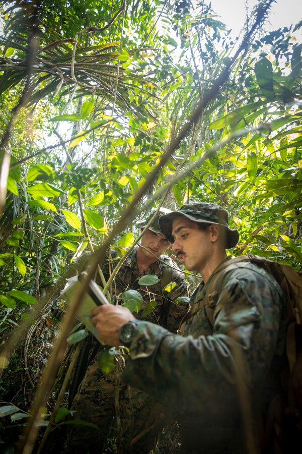 U.S. Marine Corps Sgt. Thomas Freckleton, right, and U.S. Marine Corps 2nd Lt. Robert Heinecke, left, both infantry Marines with 2d Battalion, 2d Marine Regiment, 2d Marine Division, read a map during a land navigation course as part of a bilateral jungle training event in Manaus, Brazil, Sept. 26, 2022. The Amazon jungle has significant waterways and littoral environments, the Brazilian Marines shared their vast knowledge and experience from operating along these rivers regularly. U.S. partnerships in the U.S. Southern Command area of responsibly are forged by shared challenges and common objectives. Bilateral training events such as jungle training develops and sustains relationships that improve the capacity of U.S. and partner nation maritime forces to achieve common desired effects. This exchange of knowledge between critical regional partners fosters interoperability, friendly relationships, and mutual cooperation. (U.S. Marine Corps photo by Sgt. Camila Melendez)