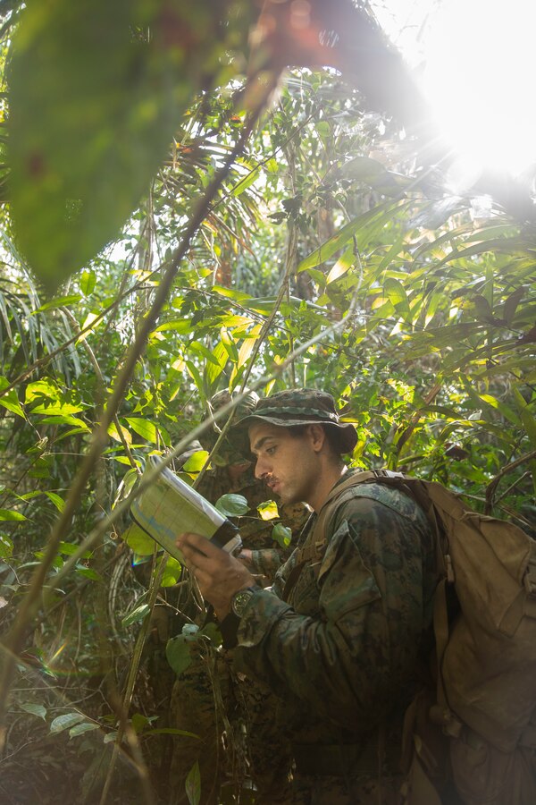 U.S. Marine Corps Sgt. Thomas Freckleton, an infantry Marine with 2d Battalion, 2d Marine Regiment, 2d Marine Division, reads a map during a land navigation course as part of a bilateral jungle training event in Manaus, Brazil, Sept. 26, 2022. The Amazon jungle has significant waterways and littoral environments, the Brazilian Marines shared their vast knowledge and experience from operating along these rivers regularly. U.S. partnerships in the U.S. Southern Command area of responsibly are forged by shared challenges and common objectives. Bilateral training events such as jungle training develops and sustains relationships that improve the capacity of U.S. and partner nation maritime forces to achieve common desired effects. This exchange of knowledge between critical regional partners fosters interoperability, friendly relationships, and mutual cooperation. (U.S. Marine Corps photo by Sgt. Camila Melendez)