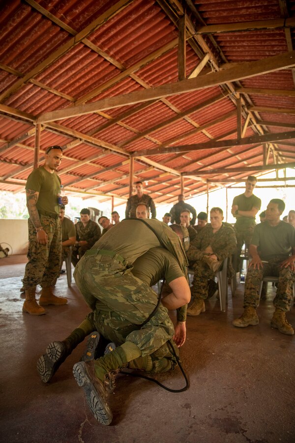 U.S. Marines and Sailors with 2d Battalion, 2d Marine Regiment, 2d Marine Division, watch as Brazilian Marines demonstrate ways to carry casualties during a first aid class as part of a bilateral jungle training event in Manaus, Brazil, Sept. 26, 2022. U.S. partnerships in the U.S. Southern Command area of responsibly are forged by shared challenges and common objectives. Bilateral training events such as jungle training develops and sustains relationships that improve the capacity of U.S. and partner nation maritime forces to achieve common desired effects. This exchange of knowledge between critical regional partners fosters interoperability, friendly relationships, and mutual cooperation. (U.S. Marine Corps photo by Sgt. Camila Melendez)
