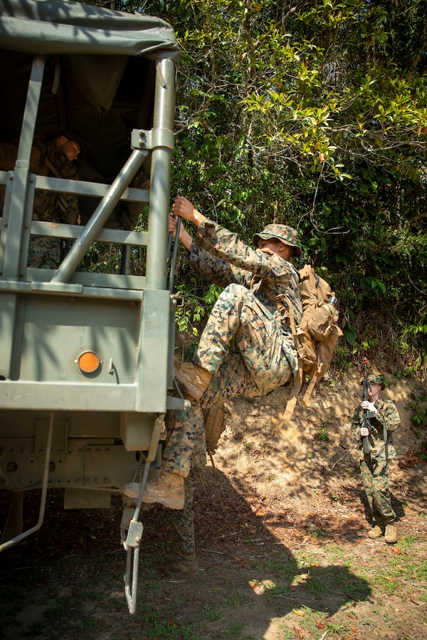 U.S. Marine Corps Lance Cpl. Anyer Torrescordoba, an infantry Marine with 2d Battalion, 2d Marine Regiment, 2d Marine Division, mounts a Brazilian vehicle prior to a raid scenario as part of a bilateral jungle training event in Manaus, Brazil, Sept. 27, 2022. Throughout the training event, U.S. Marines applied tactics and knowledge given to them by the Brazilian Marines, who regularly operate in the Amazon jungle. The U.S. integrates with partners by building trust, strengthening interoperability through training and equipment, and reinforcing a shared vision of prosperity and hemispheric security. (U.S. Marine Corps photo by Sgt. Camila Melendez)
