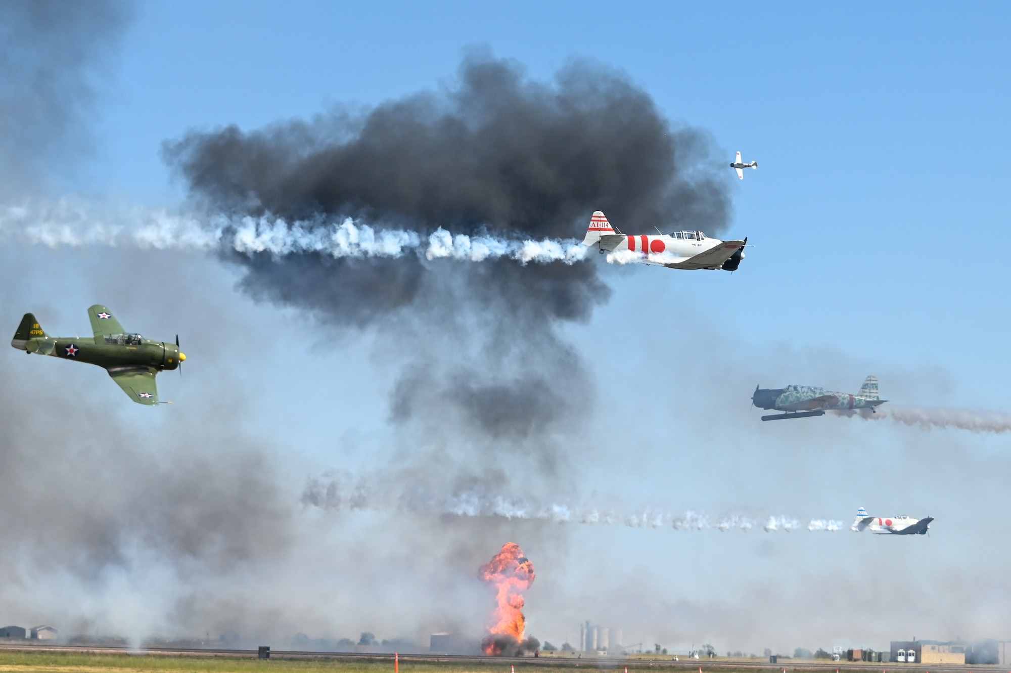 TORA! TORA! TORA! performs at the Red River Thunder airshow at Altus Air Force Base, Oklahoma, Oct. 1, 2022. The demonstration simulates the bombings and aerial flights at Pearl Harbor. (U.S. Air Force photo by Senior Airman Kayla Christenson)