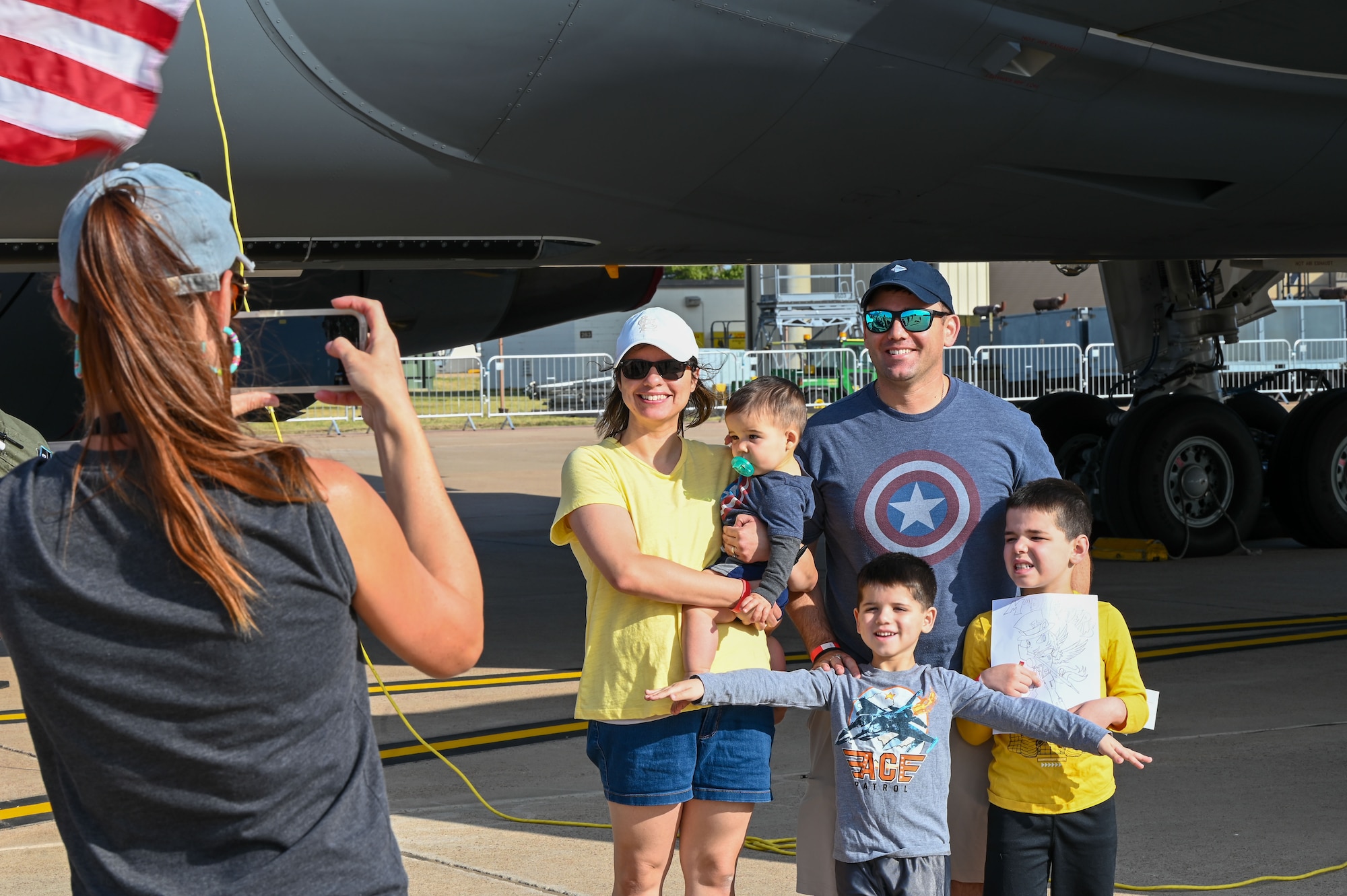 Attendees of the Red River Thunder Open House and Airshow take a photo in front of the KC-46 Pegasus at Altus Air Force Base, Oklahoma, Oct. 1, 2022. More than 20,000 people attended the airshow, including civilians, Department of Defense employees, service members and retirees. (U.S. Air Force photo by Senior Airman Kayla Christenson)