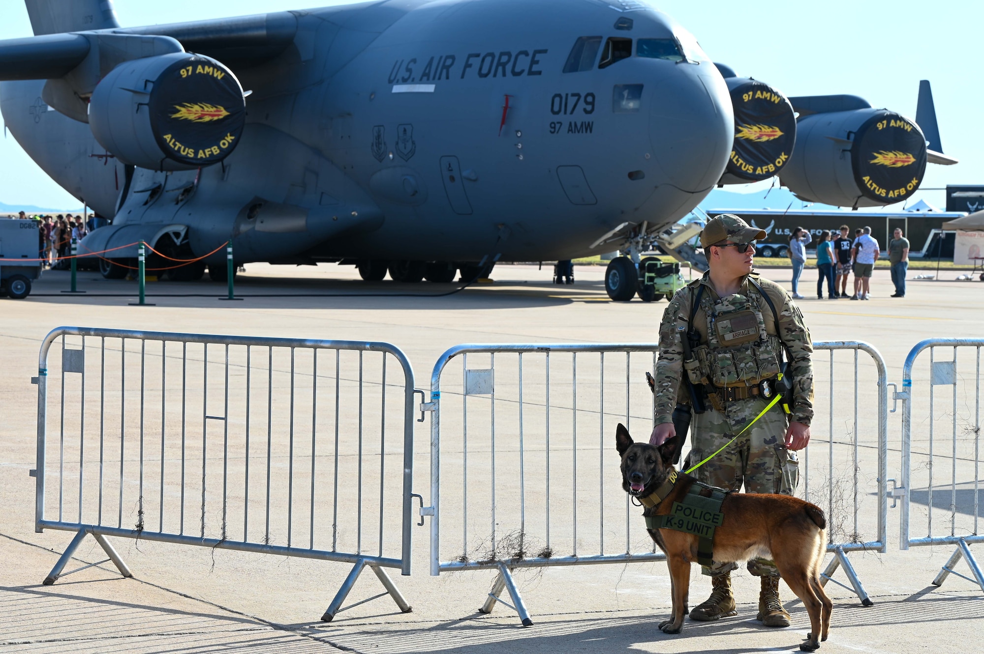 Airman 1st Class Patrick Arriaga, 97th Security Forces (SFS) military working dog (MWD) handler, and Biko, a MWD, patrol outside of the Red River Thunder airshow, at Altus Air Force Base, Oklahoma, Oct. 1, 2022. Defenders from the 97th SFS patrolled, searched and screened more than 20,000 airshow attendees. (U.S. Air Force photo by Senior Airman Kayla Christenson)