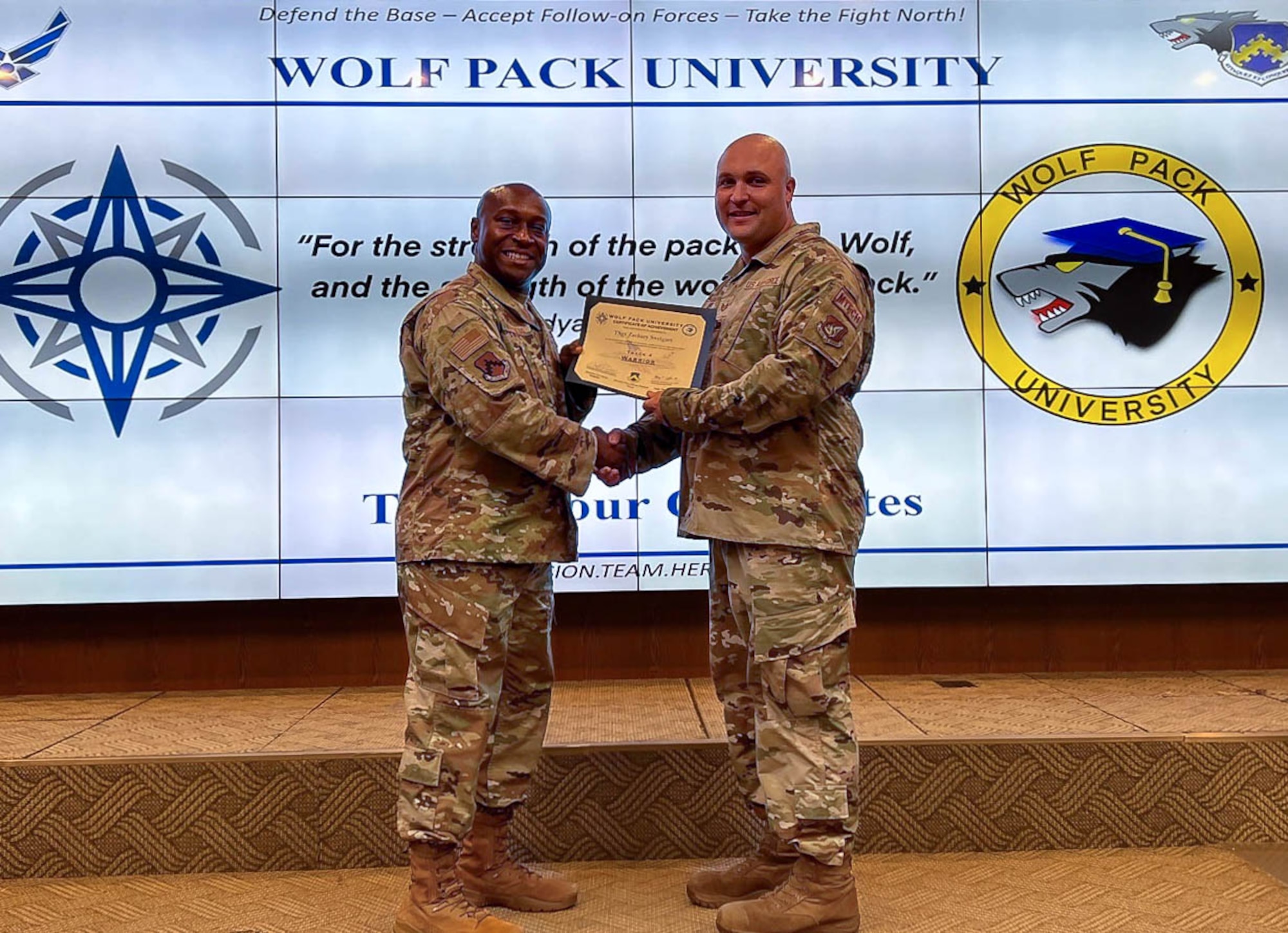 Airmen receives a certificate and poses for photo.