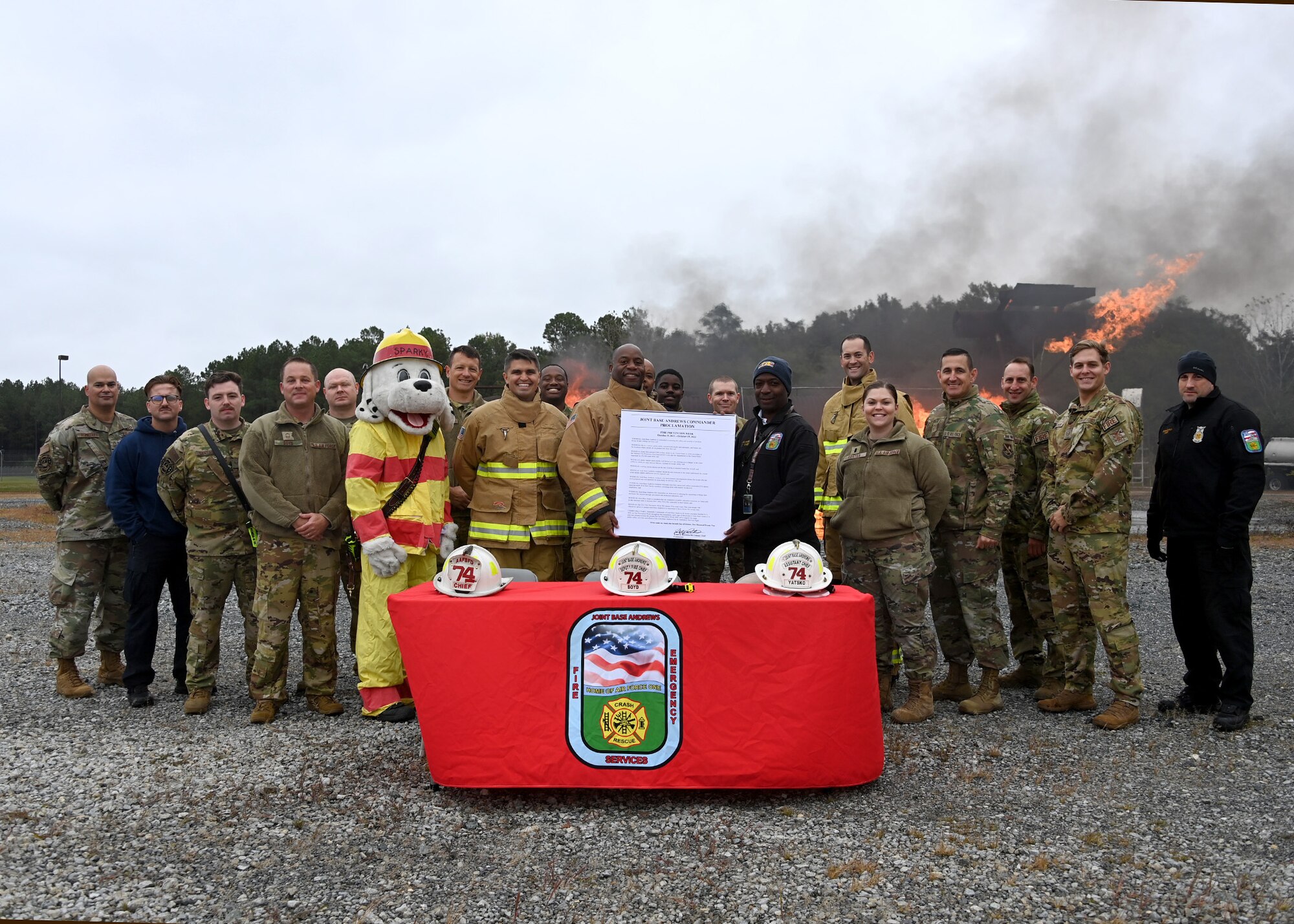 Joint Base Andrews leaders and 316th Mission Support Group personnel pose for a group photo following the signing of a Fire Prevention Week proclamation at Joint Base Andrews, Md., Oct. 4, 2022. From Oct. 9 - Oct. 15, JBA will host events such as a fire truck parade and a fire station open house and barbeque to raise fire safety awareness and educate families, students and communities across JBA. (U.S. Air Force photo by Airman 1st Class Austin Pate)