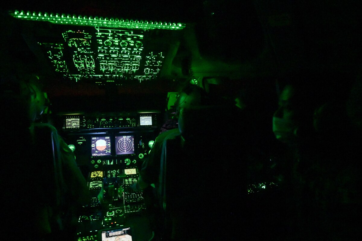 U.S. Air Force Capt. Carol Champion, 535th Airlift Squadron C-17 Globemaster III pilot, and U.S. Air Force Maj. Brittain Caldwell, 204th Airlift Squadron C-17 pilot, utilize night vision gear during a bilateral exercise with Japan Air Self-Defense Force 403rd Tactical Airlift Squadron around the Hawaiian Islands, Sept. 28, 2022. The 3-day training focused on interoperability between the Kawasaki C-2 and C17 to advance best practices for future operations within the Indo-Pacific region. (U.S. Air Force photo by Staff Sgt. Alan Ricker)