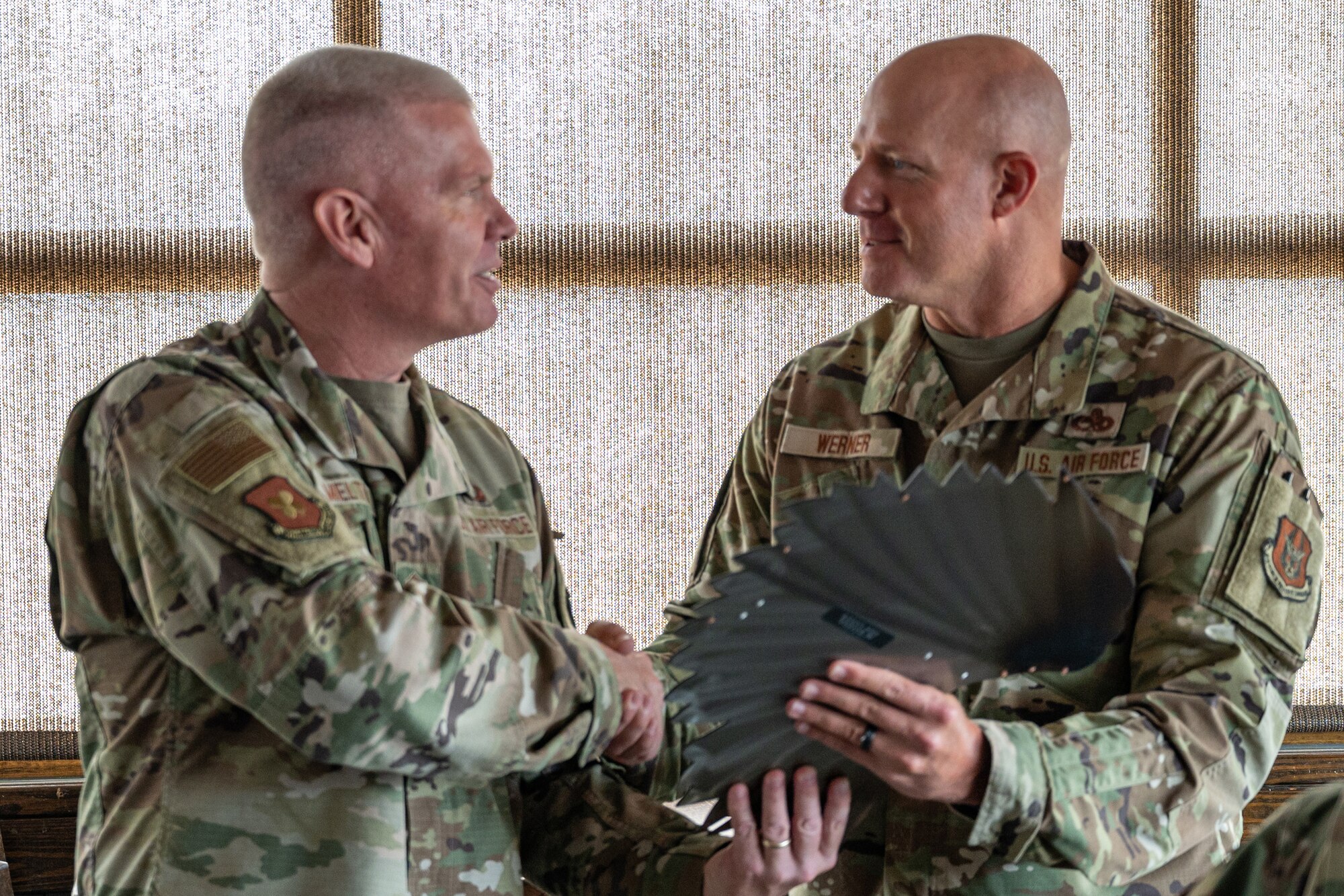 Two Airmen shaking hands