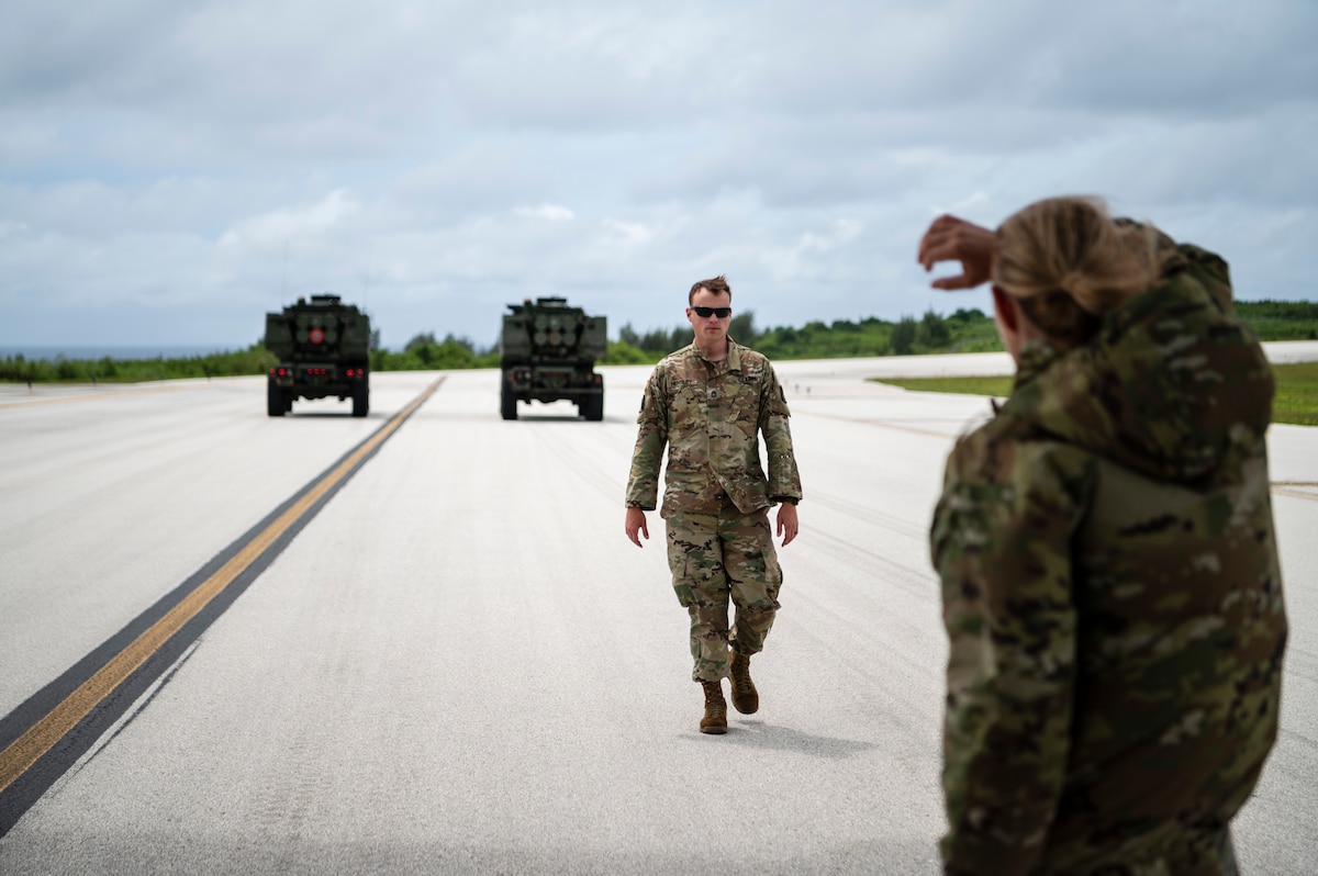 A man walks on a flightline