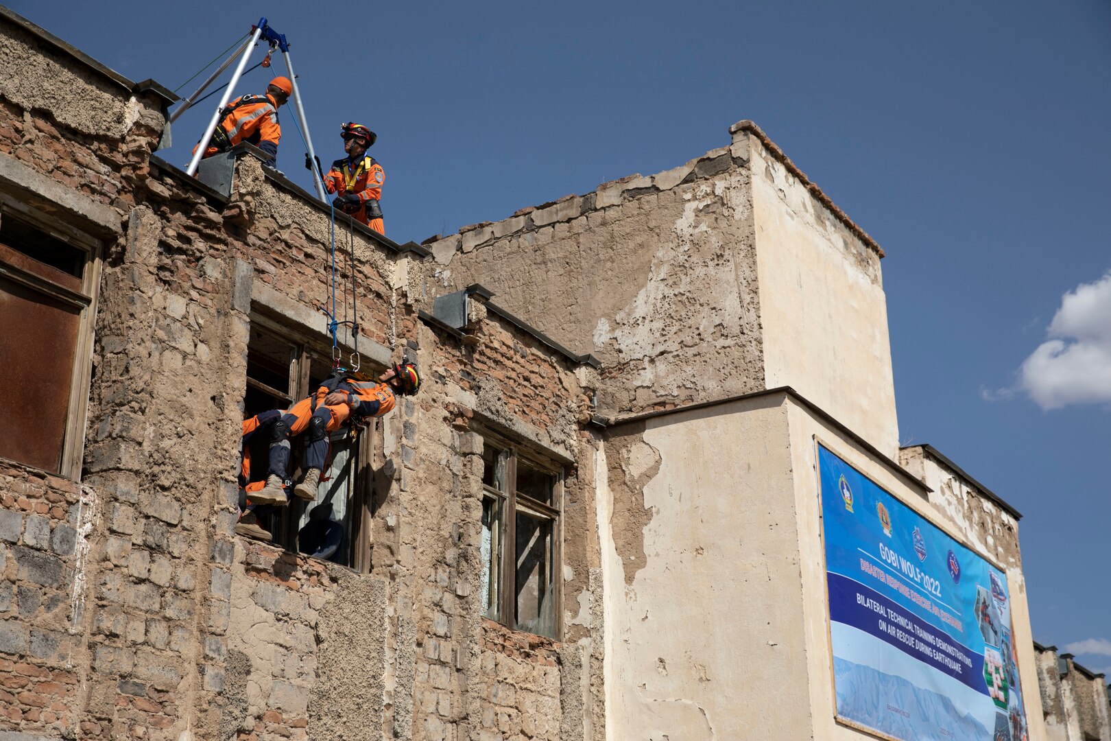 Chief Master Sgt. Caleb Guthemiller, far left, 141st Fatality Search and Rescue Recovery, assists in training Mongolian National Emergency Management Agency personnel in high-angle rope rescue during a simulated search and rescue scenario as part of exercise Gobi Wolf 2022 in Bayankhongor, Mongolia, Sept. 7, 2022. Gobi Wolf is a multilateral humanitarian assistance and disaster relief engagement between military components of the government of Mongolia and U.S. Army Pacific.