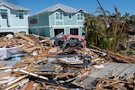 Members of the 202nd Rapid Engineer Deployable Heavy Operational Repair Squadron Engineers (RED HORSE) Squadron, Florida Air National Guard, clear roads of Hurricane Ian debris in Fort Myers Beach, Florida, Oct. 1, 2022. The 202nd RED HORSE Squadron, stationed at Camp Blanding, Florida, is a specialized, highly mobile civil engineering team of Florida Air National Guard members.